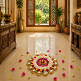 A vibrant circular rangoli mat with white and pink flower design and gold accents featuring a tea light candle holder