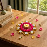 A vibrant pink pom-pom tea light candle holder with gold metallic accents for Diwali pooja and festive home decor