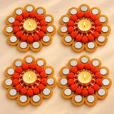 Orange pom-pom rangoli mat tealight candle holder with gold-rimmed mirror diya stand for festive home decor