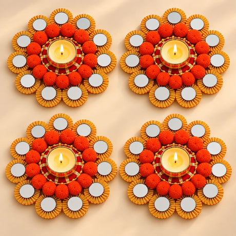 Orange pom-pom rangoli mat tealight candle holder with gold-rimmed mirror diya stand for festive home decor