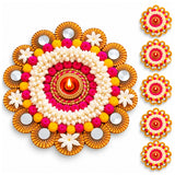 Vibrant tealight candle holder rangoli mat with central lit diya and pink yellow white floral embellishments on golden base