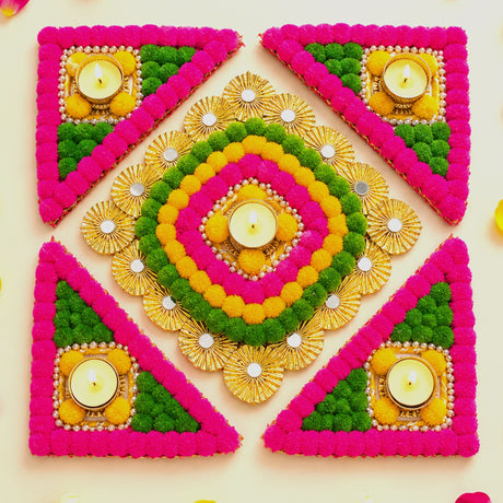 Rangoli mat with vibrant pink green yellow pom-poms gold accents and lit tea light candle holder for festive decor