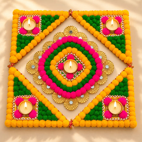 Vibrant yellow green and pink floral rangoli mat with gold accents and four lit tea light candle holders for diwali decor