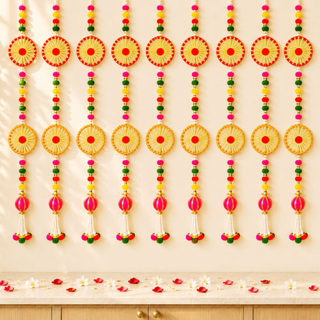 Vibrant handcrafted 2 strings wall backdrop hanging with woven red and gold pompom wheels beads and pink tassels for Diwali decor