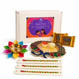 Colorful peacock-shaped enamel and gold tray in Bhai Dooj gift hamper with haldi kumkum holder and rakhi set