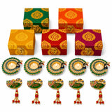 Set of five ornate green and gold peacock-themed candle holders with lit tealights for Diwali gift hamper