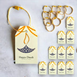 Cream-colored printed paper happy diwali gift tag with purple diya design orange border and yellow string attached