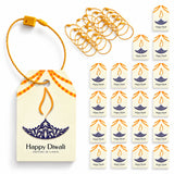 Cream-colored paper diwali gift tag with blue and orange lamp design attached to yellow string for hanging gifts