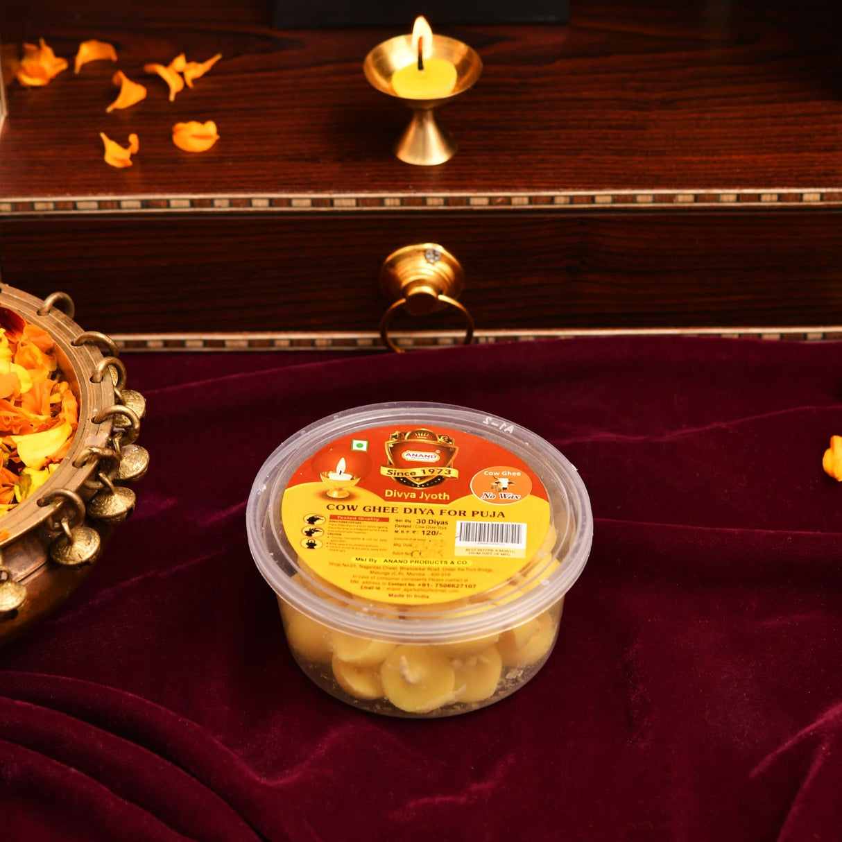A clear plastic container of golden-yellow divya jyoth pure cow ghee wicks made from butter cotton for puja use