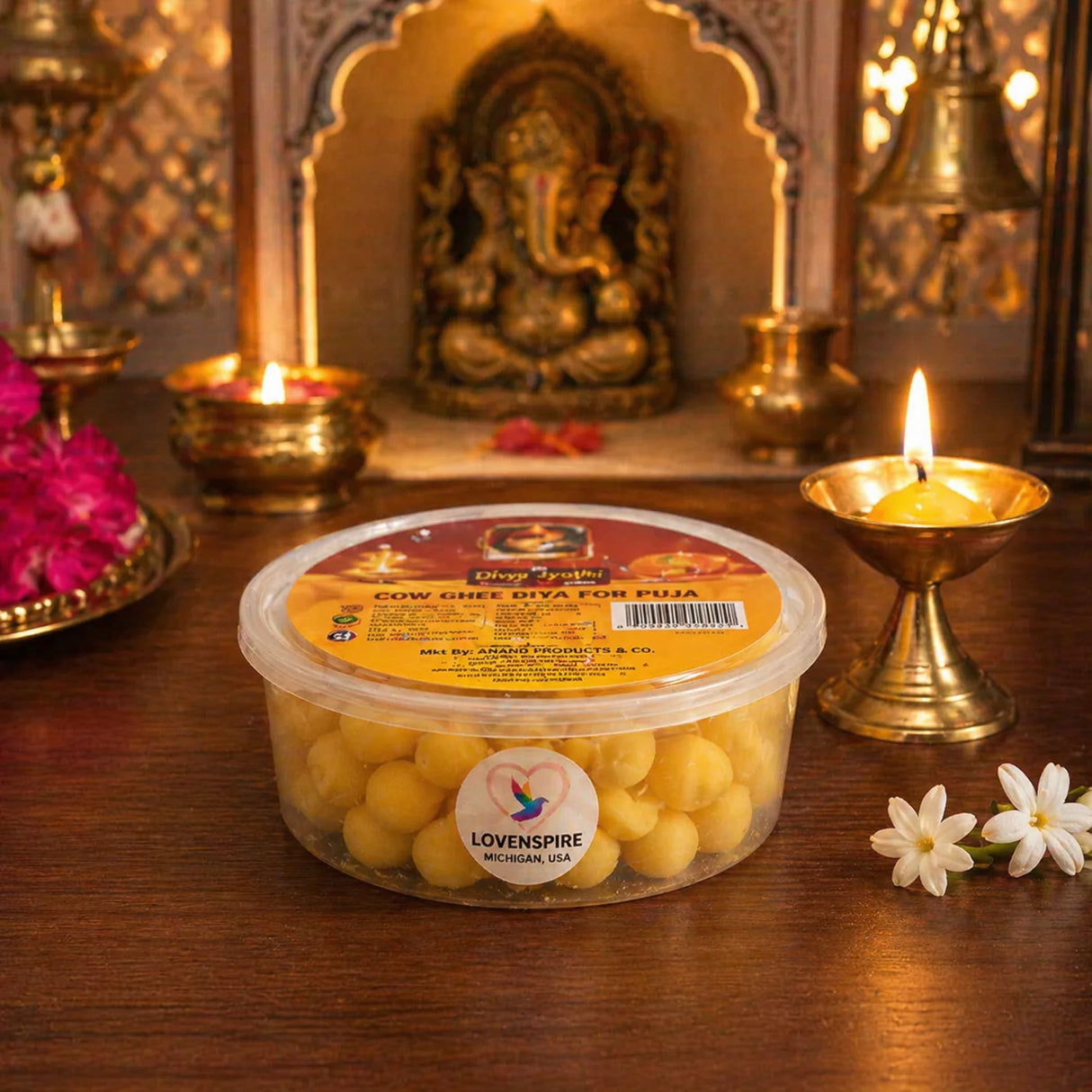 Clear plastic container of golden-yellow cow ghee diyas branded lovenspire divya tyagi for pooja and diwali use