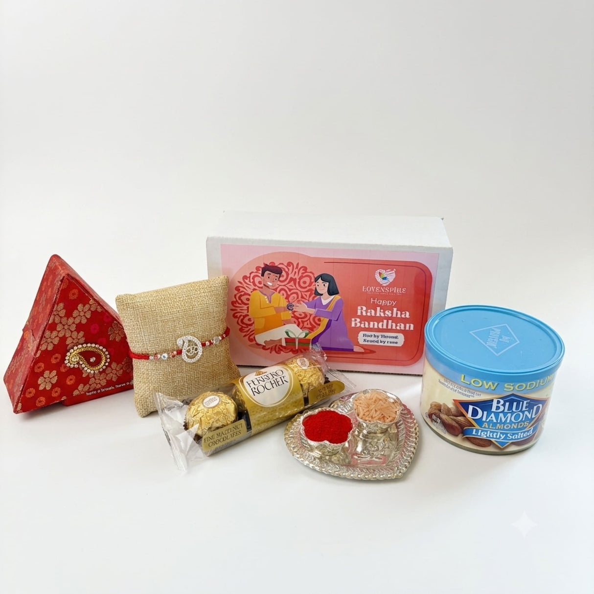 Red and gold patterned brocade triangular gift box with decorative paisley clasp in pure silver om rakhi gift hamper for brother