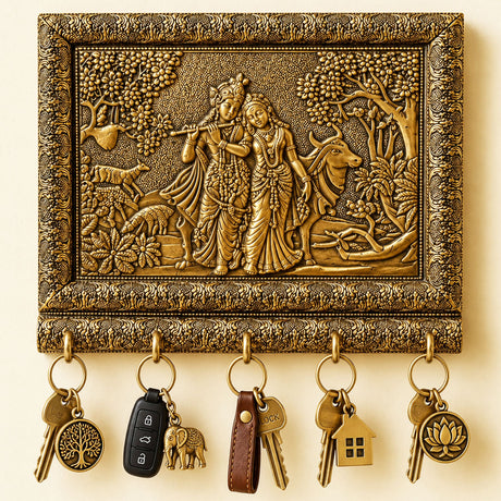Golden ornate hand crafted radha krishna key holder with pastoral relief and floral scrollwork for home entryway organization