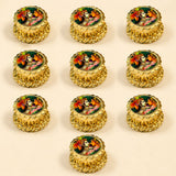 Golden ornate haldi kumkum holder boxes with intricate heart embossing and colorful Radha Krishna deity images