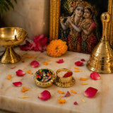 Gold-colored ornate radha krishna haldi kumkum holder with intricate lid and two compartments for white and red powder