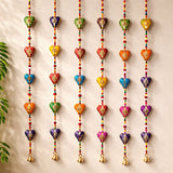 Colorful rajasthani heart-shaped door hanging wind chimes with intricate patterns and small bells for festive decor