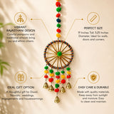 A vibrant rajasthani style ring wall hanging with wooden frame colorful pom poms and golden bells for home decor