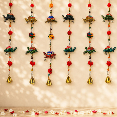 Colorful hand-painted rajasthani turtle-shaped door hanging wind chimes with red pom-poms and brass bells for home decor