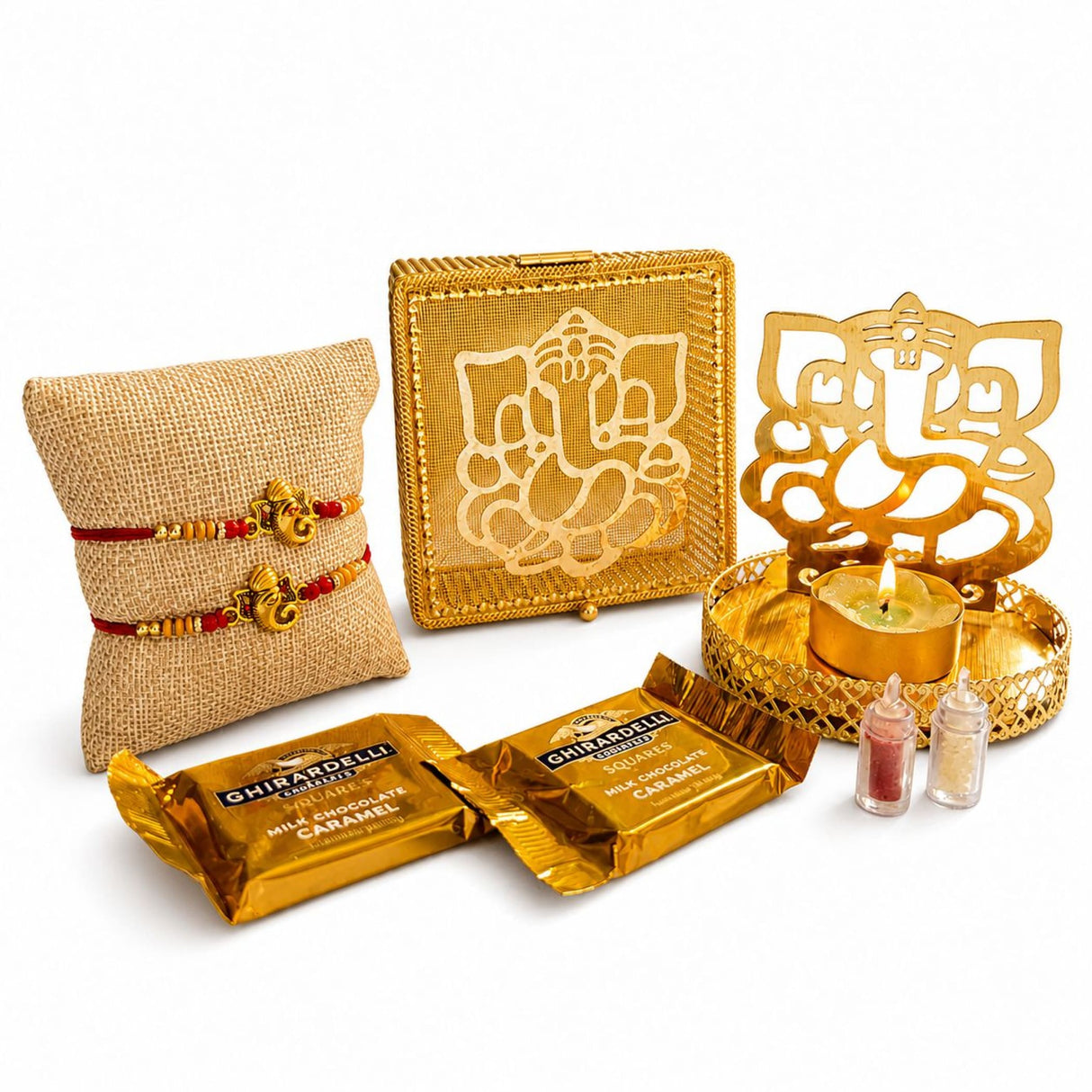Golden ganesha-themed decorative metal tray with intricate cut-out design and lit candle for raksha bandhan gift hamper