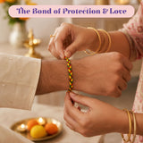 Rakhi gift hamper set featuring a colorful handmade braided raksha bandhan bracelet in red yellow and green