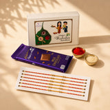 Rakhi gift hamper set for brother and bhabhi featuring purple cadbury dairy milk chocolate bar with gold foil wrapper and square chocolate piece
