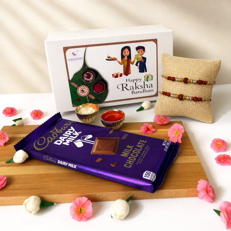 Rakhi gift hamper for brother and bhabhi featuring a purple cadbury dairy milk chocolate bar with gold foil branding and a visible piece