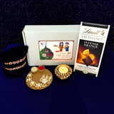 Raksha Bandhan gift set with Rakhi bracelets, chocolates, tealight holder, and gift pack