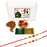 Gold-colored decorative tray with red rose embellishments and central raksha design for raksha bandhan gift hamper