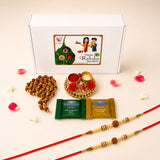 Red rakhi with golden and beaded embellishments included in raksha bandhan gift hamper for brother and bhabhi
