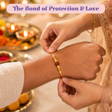 Raksha bandhan gift hamper featuring a red and gold handmade rakhi with dark brown and small golden beads