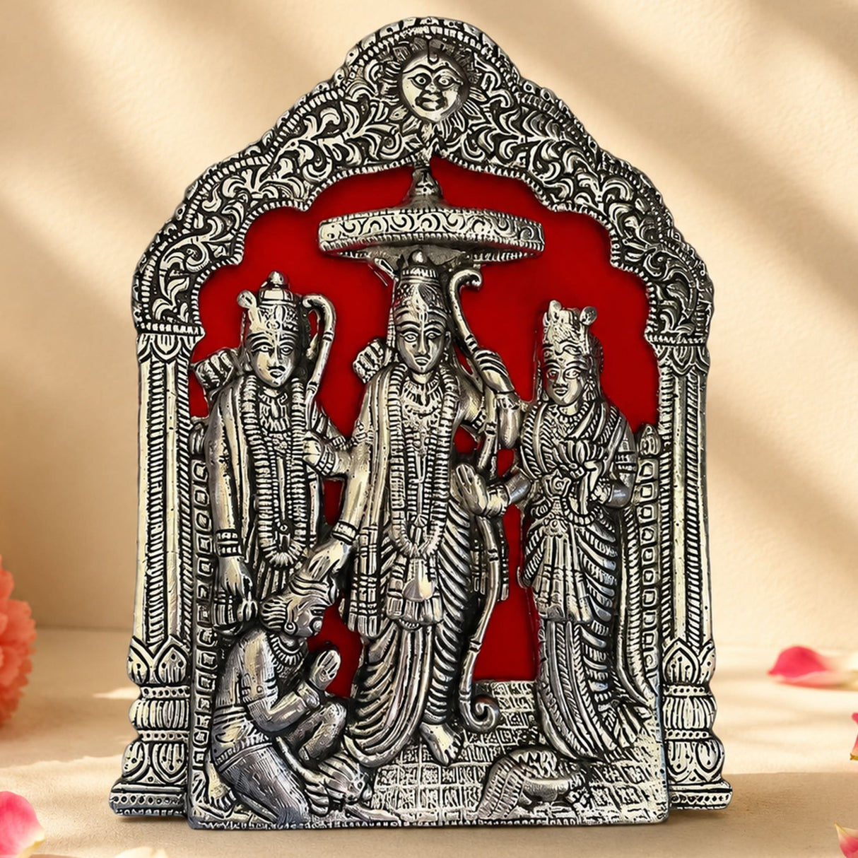 Silver-colored ornate metal plaque depicting vishnu lakshmi and garuda in an arched frame for pooja and home decor