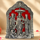 Silver-colored ornate metal plaque depicting vishnu lakshmi and garuda in an arched frame for pooja and home decor
