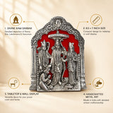 Silver metallic ram darbar metal art plaque with intricate carvings of rama sita lakshmana and hanuman on red background