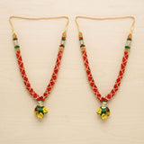 Red and gold woven idol mala necklace with green accents and yellow floral satin pendant for pooja and temple decor