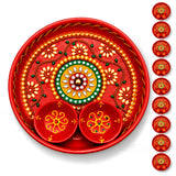 Decorative pooja thali metal plate in vibrant red with gold and green floral patterns and attached matching bowls for haldi kumkum