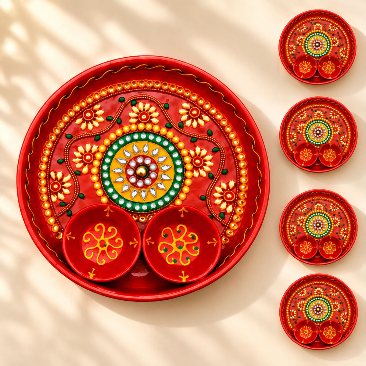 Decorative pooja thali red metal serving tray with intricate gold green yellow floral patterns and attached bowls for rituals