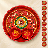 Decorative pooja thali metal plate in red with gold green floral patterns and attached bowls for haldi kumkum rituals
