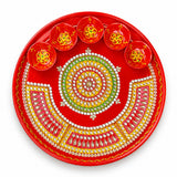Pooja thali with 5 diya bowls featuring vibrant red paint and intricate gold green white beadwork for aarti rituals