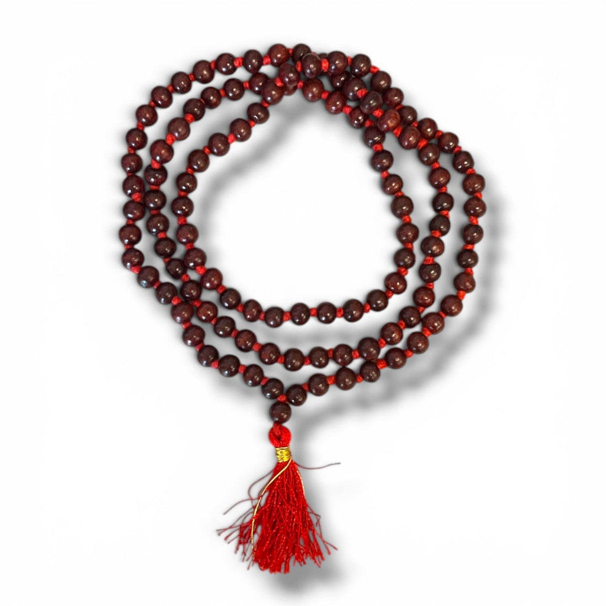 A dark brown wooden bead 108 beads red sandalwood mala with red tassel and gold accent for meditation yoga and prayer