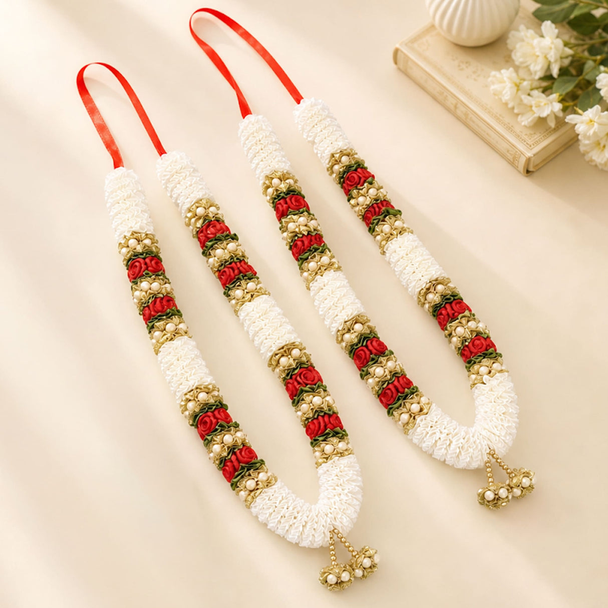 Elegant white red and gold artificial wedding varmala with pearl accents and decorative tassels for bride and groom