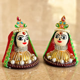 Two intricately decorated goddess riddhi siddhi idols with jeweled crowns and pearl embellishments for pooja decor