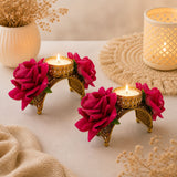 Gold-toned ornate rose Diwali candle holders with intricate detailing and vibrant pink artificial roses for festive decor