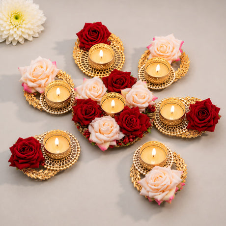 Gold-colored ornate rose tea light candle holders with intricate lace-like patterns for festive Diwali and Rangoli decor