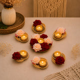 Gold-toned metal rose tea light candle holders with woven design and red or peach roses for festive rangoli decor set of 7