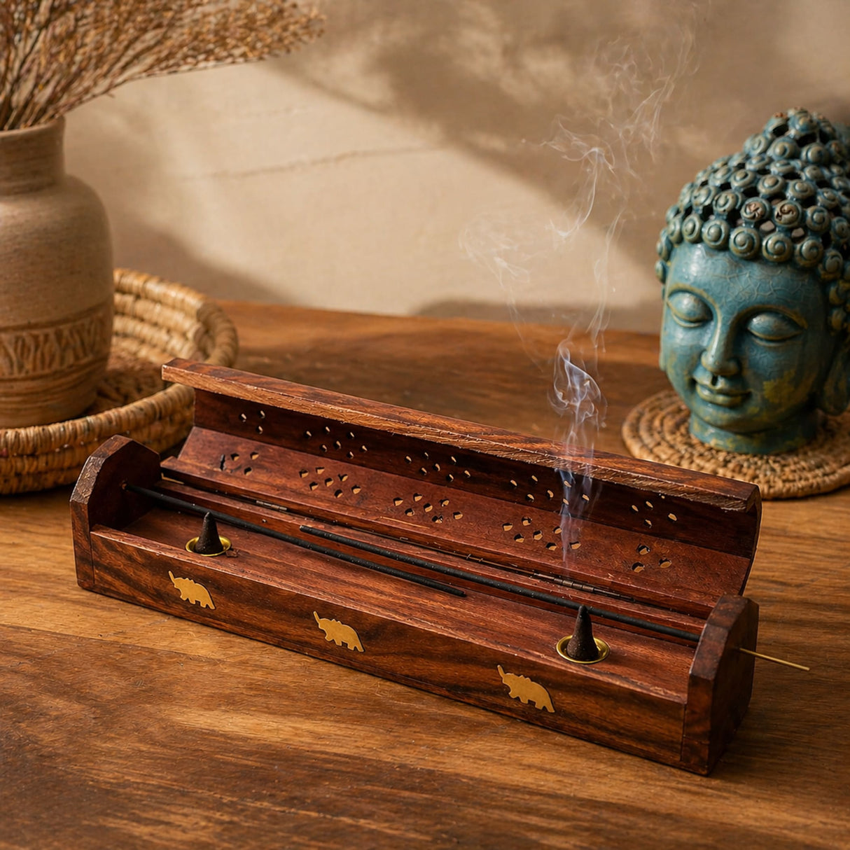 Handmade rosewood incense stick holder with gold elephant inlays and perforated top emitting gentle smoke