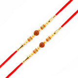 Two red thread rakhi bracelets with golden beads and central brown rudraksha beads for raksha bandhan gift hamper