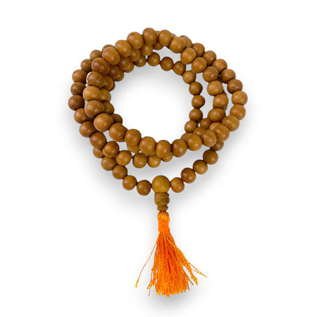 A warm brown sandalwood mala with vibrant orange tassel used as a 108 meditation and Buddhist prayer necklace