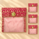 A vibrant pink and gold embroidered fabric saree cover with button closure and decorative golden flower clasp for storage