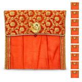 Ornate orange and gold embroidered fabric saree cover with central golden floral clasp and button closure for storage