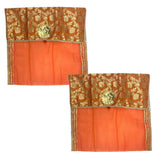 Orangish-orange sheer fabric saree covers with gold embroidered tops and metallic flower accents for wardrobe storage