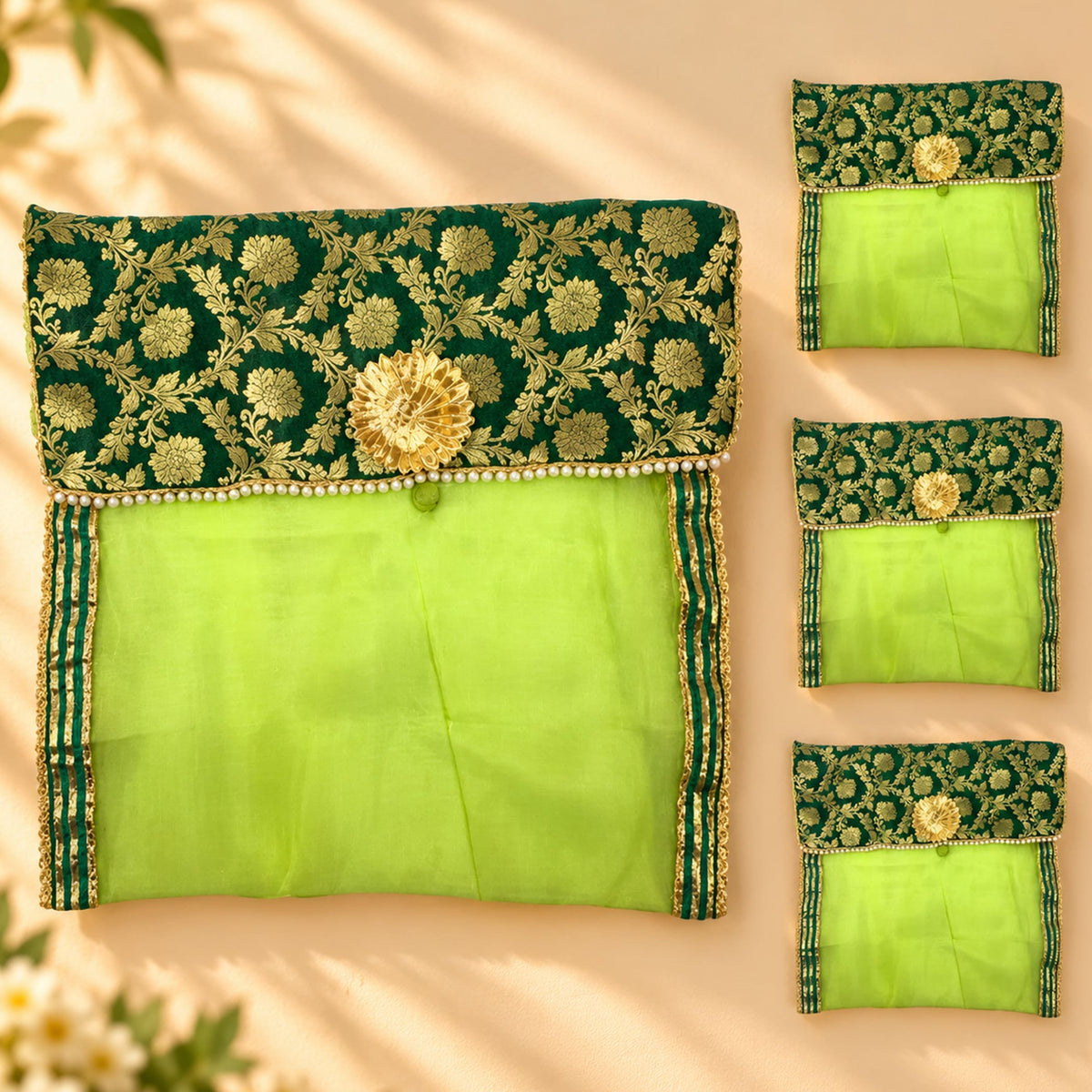 Green embroidered saree cover pouch with gold floral detailing and pearl trim for wardrobe storage and travel use